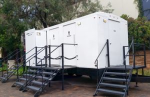 Luxury portable toilet trailer at an outdoor event